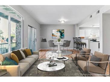 Inviting living room featuring an open concept design with modern decor and lots of natural light at 2575 S Syracuse Way # 101, Denver, CO 80231