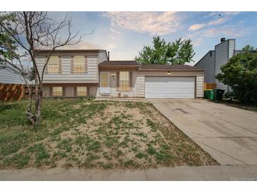 Inviting two-story home featuring a manicured front yard and attached two-car garage at 19053 E 22Nd Dr, Aurora, CO 80011