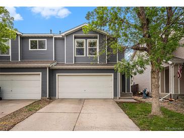 Charming two-story home with a large two car garage and driveway at 814 Pintail Ave, Brighton, CO 80601