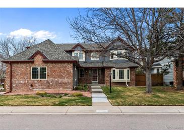 Charming two-story home with a brick and gray exterior, landscaped front yard and inviting curb appeal at 16273 E Prentice Pl, Centennial, CO 80015