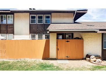 Charming townhouse featuring a private, fenced front patio and neutral stucco facade at 3820 S Fraser St, Aurora, CO 80014