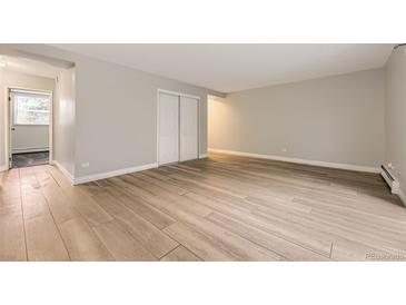 Spacious bedroom with light wood flooring and ample closet space at 2160 S Vaughn Way # 104C, Aurora, CO 80014