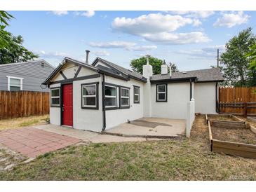 Charming backyard with garden beds, patio, and a cozy exterior at 1301 Kenton St, Aurora, CO 80010