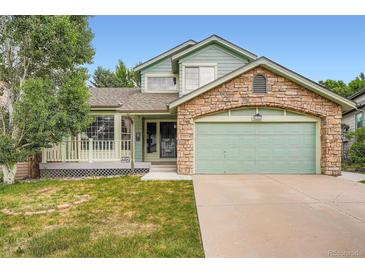Charming two-story home with a stone-accented garage, porch, and well-maintained lawn at 5362 S Danube Ct, Centennial, CO 80015