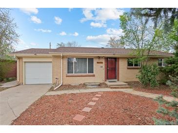 Charming single-story brick home with a well-manicured lawn and attached single car garage at 3117 Victor St, Aurora, CO 80011