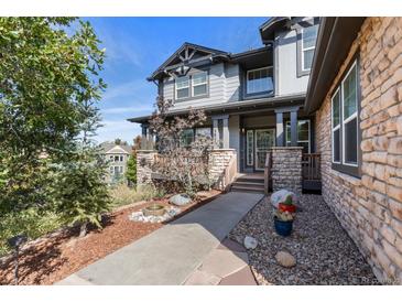 Charming two-story home with stone accents, manicured landscaping, and inviting front porch at 1519 Stonehill Ct, Castle Rock, CO 80104