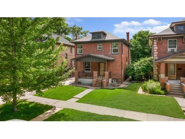Charming two-story red brick home with a well-maintained front yard and inviting porch at 2849 N Vine St, Denver, CO 80205