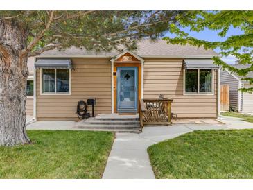 Charming home featuring a well-kept lawn, quaint porch, and welcoming blue front door at 430 at 430 Osceola St, Denver, CO 80204