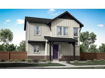 Two-story house with light beige and dark brown siding, purple door, and landscaping at 5772 N Jebel Way, Aurora, CO 80019