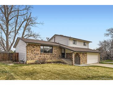 Charming two-story home with brick facade, well-maintained lawn, and attached two car garage on a sunny day at 789 Hamal Dr, Lone Tree, CO 80124