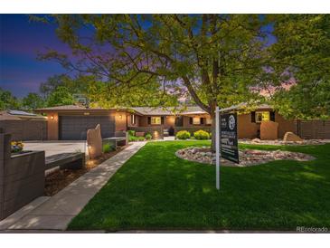 Charming brick home with lush lawn, mature trees, and for sale sign at 12256 W 34Th Pl, Wheat Ridge, CO 80033