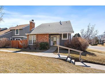 Charming exterior view of a single-Gathering home featuring brick and siding under a gray roof at 8699 Garrison Ct, Arvada, CO 80005