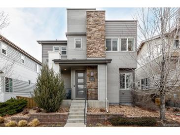 Beautiful two-story home with stone accents and a well-manicured front yard at 9694 Dunning Cir, Highlands Ranch, CO 80126