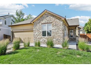 Charming home with a stone facade, well-manicured lawn, and an attached two-car garage at 19677 E Vassar Dr, Aurora, CO 80013
