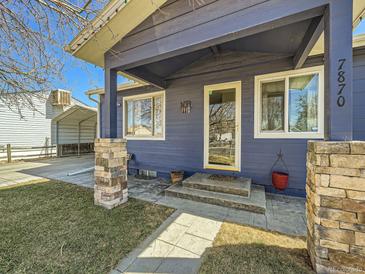 Charming front entrance with stone accents and well-maintained landscaping at 7870 Kimberly St, Commerce City, CO 80022