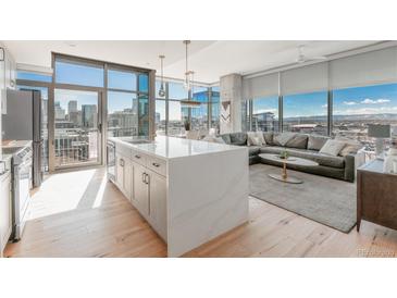 Bright living room featuring city views, modern furnishings, and a spacious open concept layout at 1700 Bassett St # 1808, Denver, CO 80202
