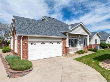 Charming home with a well-maintained front yard, brick accents, and a two-car garage at 3205 E 102Nd Pl, Thornton, CO 80229