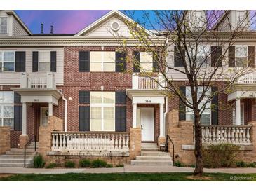 Charming brick townhome featuring a cozy front porch and well-maintained landscaping at 3818 S Dallas St, Aurora, CO 80014