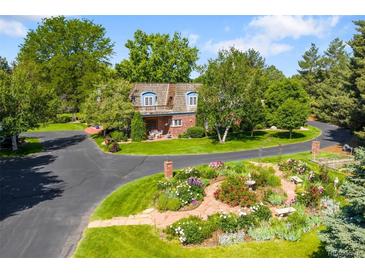Beautifully landscaped home with a circular driveway and mature trees at 4181 S Colorado Blvd, Cherry Hills Village, CO 80113