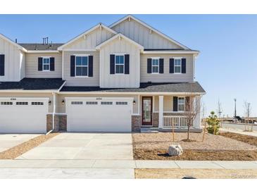 New construction townhome featuring a two-car garage and covered porch at 6554 N Malta St, Aurora, CO 80019