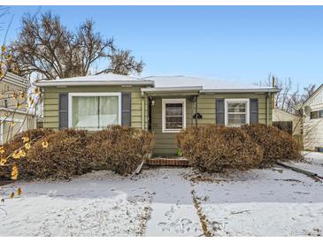 Charming single-story home featuring green siding, black shutters, and snowy landscaping at 1651 S Elizabeth St, Denver, CO 80210