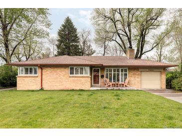 Charming one-story brick home with a well-manicured lawn and inviting front porch at 9000 W 4Th Pl, Lakewood, CO 80226