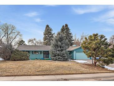 Charming single-story home features a well-maintained lawn and mature trees at 3831 S Hillcrest Dr, Denver, CO 80237