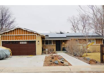 Charming single-story home featuring solar panels, a two-car garage, and low-maintenance landscaping at 310 S Marshall St, Lakewood, CO 80226