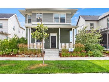 Charming two-story home featuring a welcoming porch and well-maintained landscaping at 5925 Hanover St, Denver, CO 80238
