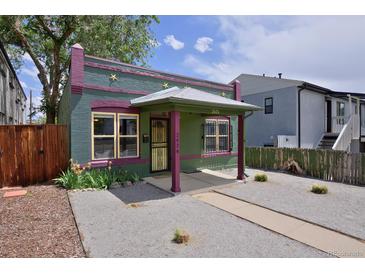 Charming single-story home featuring an inviting porch, decorative stars, and low-maintenance gravel landscaping at 2424 N Clay St, Denver, CO 80211