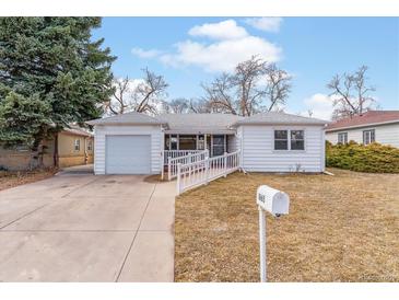 Charming single-story home with a well-maintained yard, ramp, and detached one car garage, perfect for accessibility at 1665 Yukon St, Lakewood, CO 80214