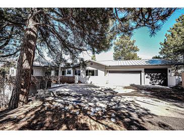 Inviting exterior showcasing a home with a spacious driveway and attached garage at 18155 Flowered Meadow Ln, Monument, CO 80132