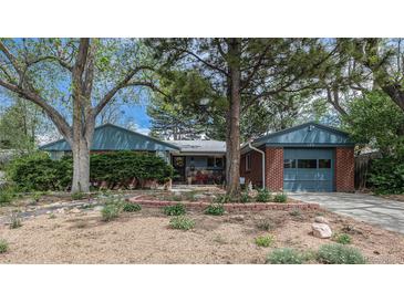 Charming single-story home with brick accents, mature trees, landscaping and attached garage at 120 Field St, Lakewood, CO 80226