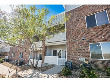 Multi-level condo building with brick facade and well-maintained landscaping on a sunny day at 10149 W 55Th Dr # 3, Arvada, CO 80002