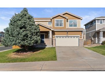 Charming two-story home with a well-maintained lawn and a two-car garage at 2736 Poplar Grove Pl, Castle Rock, CO 80109