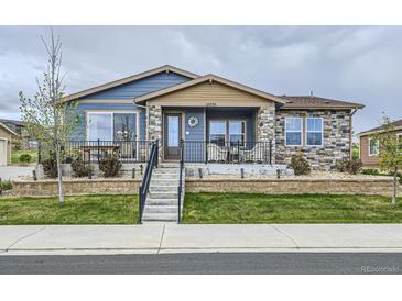 Charming single-Gathering home with stone accents, landscaped yard, and welcoming front porch at 12930 Bobcat Ct, Broomfield, CO 80021