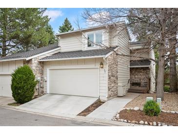 Charming home featuring stone accents, a two-car garage, manicured lawn, and inviting curb appeal at 4605 S Yosemite St # 36, Denver, CO 80237