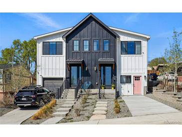 Modern farmhouse-style duplex with contrasting black and white siding and inviting curb appeal at 949 Raleigh St # 2, Denver, CO 80204