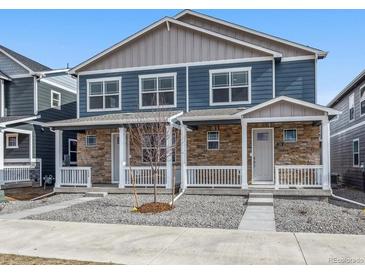 Charming two-story townhome with a stone facade and a small, well-maintained front yard at 22292 E 7Th Pl, Aurora, CO 80018