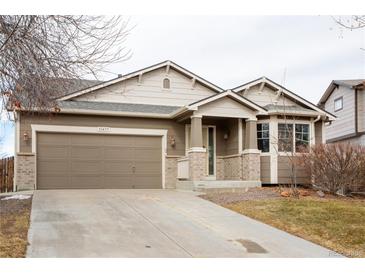 Beautiful ranch-style home with a two-car garage and well-manicured lawn at 11477 Iola St, Commerce City, CO 80640