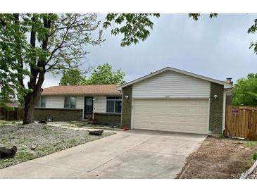 Ranch home with brick accents, neutral siding, well kept lawn, and an attached two-car garage at 3190 S Joplin Ct, Aurora, CO 80013