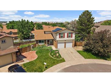 Charming two-story home with attached two-car garage, solar panels, manicured lawn and mature trees at 11149 Seton Pl, Westminster, CO 80031