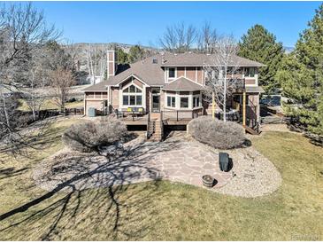 Expansive backyard with stone patio, deck, mature trees and landscaping offers great outdoor space at 6406 Eagle Ct, Longmont, CO 80503