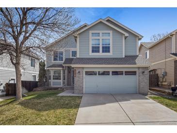 Charming two-story home featuring a two-car garage, well-maintained lawn, and beautiful exterior paint at 8414 Bed Straw St, Parker, CO 80134