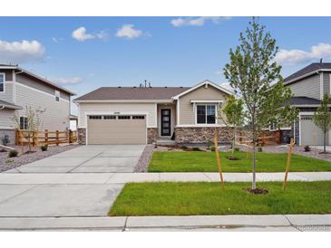 Charming one-story home with a well-manicured lawn, stone accents, and an attached two-car garage at 24780 E 39Th Ave, Aurora, CO 80019