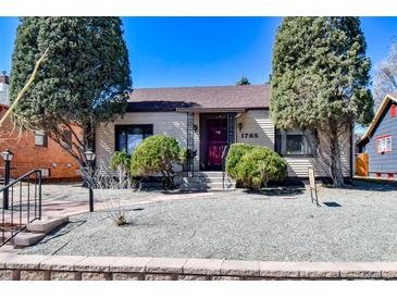 Charming home with a well-maintained front yard, bushes, trees, and a beautiful stone facade at 1765 S Franklin St, Denver, CO 80210
