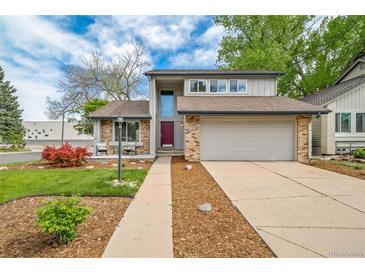 Charming two-story home featuring brick accents, a two-car garage, and a well-maintained front yard at 6398 S Emporia Cir, Englewood, CO 80111