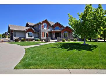 Charming two-story home featuring a lush, green lawn and manicured landscaping at 1315 W 141St Cir, Westminster, CO 80023