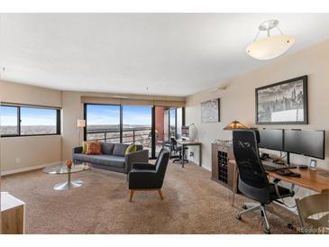 Living room with city views and modern furniture at 100 Park W Ave # 1804, Denver, CO 80205