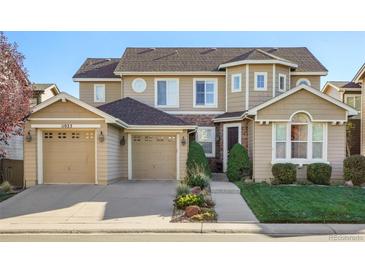 Charming home featuring a two-car garage and beautifully landscaped front yard at 11023 Glengate Cir, Highlands Ranch, CO 80130